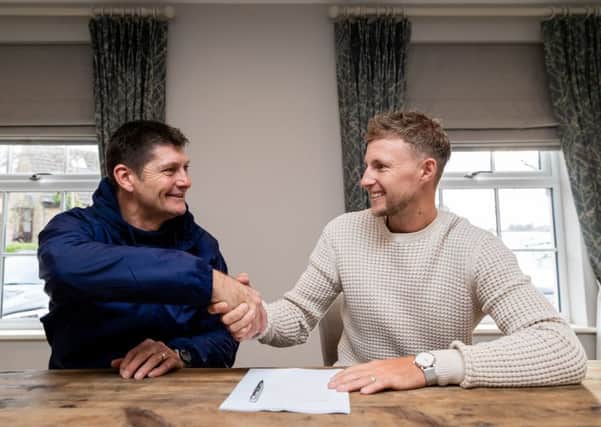 STICKING AROUND: Yorkshire County Cricket Club's Joe Root is pictured with Director of Cricket Martyn Moxon as he signs a new contract with the club. Picture: Alex Whitehead/SWpix.com