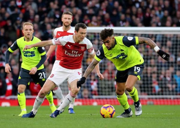 In the thick of it: Huddersfield Town's Danny Williams and Arsenal's Stephan Lichtsteiner battle for the ball.