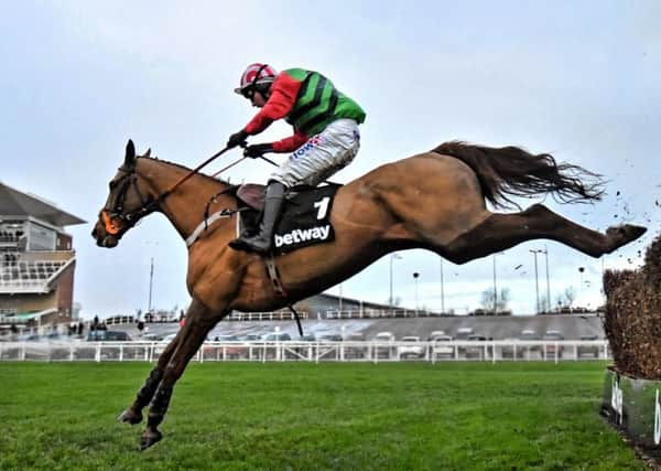 Definitly Red won a second successive Many Clouds Chase at Aintree under Danny Cook.