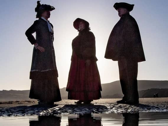 Pam Harrison, Kieth Harrison, dressed as a traditional town crier and Suzanne Dekker. Picture: Charlotte Graham.