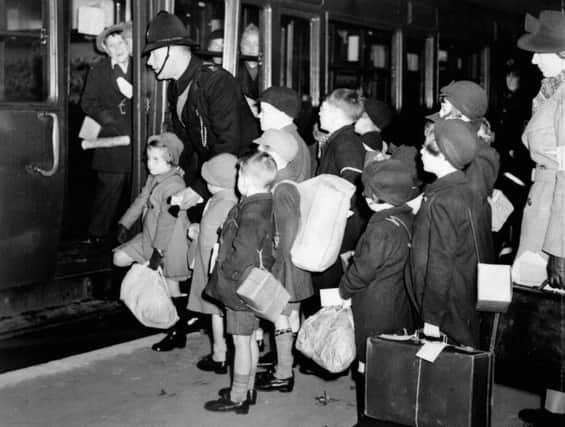 London schoolchildren carry gas masks and luggage September 1, 1939, as they leave by train for evacuation to Devon at the start of the Second World War.