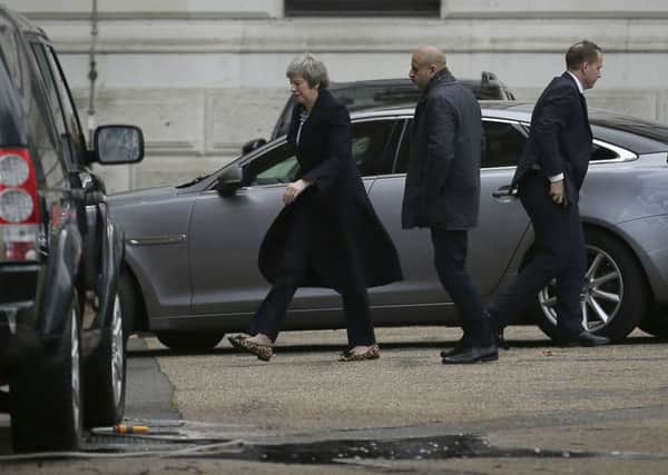 A crestfallen Theresa May returns to 10 Downing Street shortly before pulling the Commons vote on her Brexit deal.
