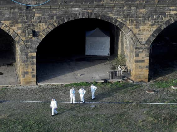 Scene of crime officers work at the viaduct