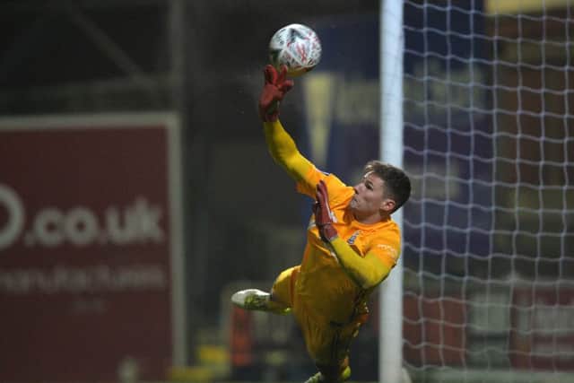 Ben Wilson can't quite reach one of the Peterbrough penalties at Valley Parade last night. Picture: Bruce Rollinson