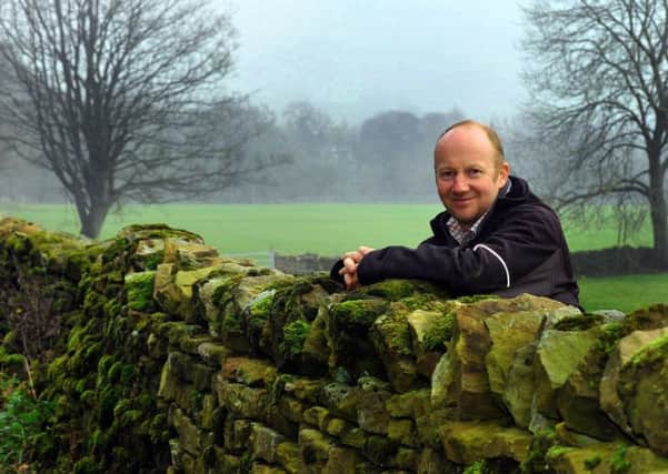 Stuart Raw leaning on a dry stone wall on his farm at Castle Bolton in Wensleydale. Pictures by Gary Longbottom.