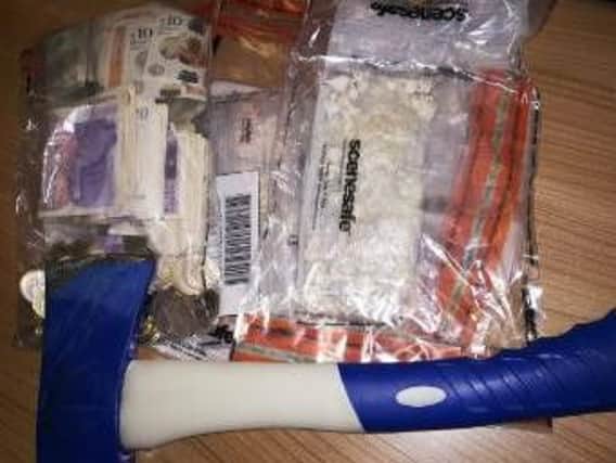 An axe, drugs and cash were seized