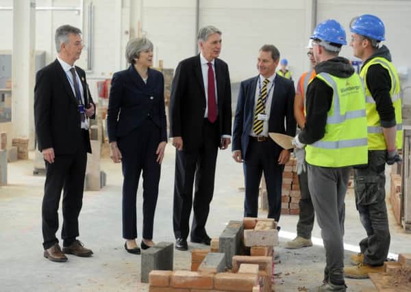 Theresa May and Philip Hammond meet apprentices at the Leeds College Building after the Budget in November 2017.