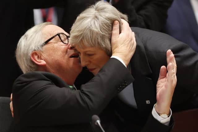 European Commission President Jean-Claude Juncker, left, greets British Prime Minister Theresa May during a round table meeting at an EU summit in Brussels.