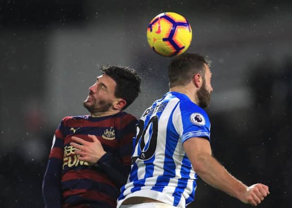 Newcastle United's Fabian Schar (left) and Huddersfield Town's Laurent Depoitre (right) battle for the ball.