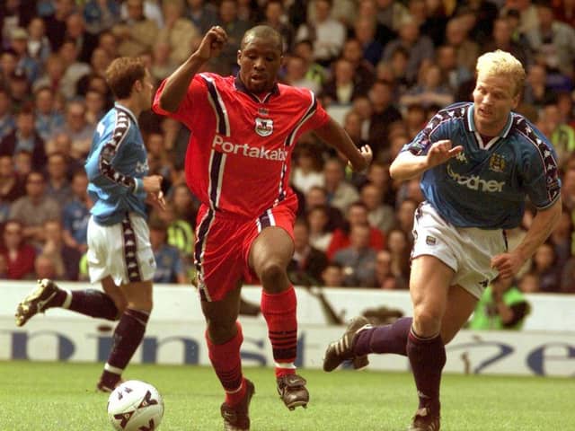 On the attack: York's Rodney Rowe goes past the Manchester City defence.