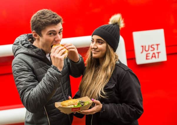 JUST EAT: Just Eat launch their new lunch collection service with a giant lunchbox in Leeds City Square, West Yorks., November 07 2018. See release: A giant red lunchbox has appeared in Leeds City Square taking passers-by by surprise. The structure, which stands at two metres tall and four metres wide, appeared overnight and has caught the attention of commuters and office workers, who stopped to pose for selfies.