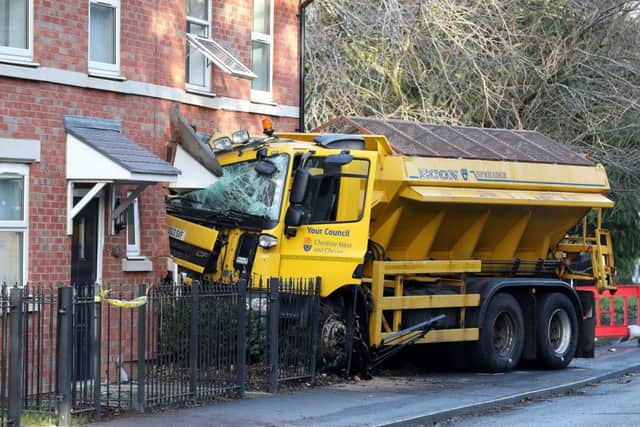 A gritting lorry embedded in a house in Chester Road in Helsby, Cheshire, after it left the road earlier this morning. Picture by Martin Rickett/PA Wire.