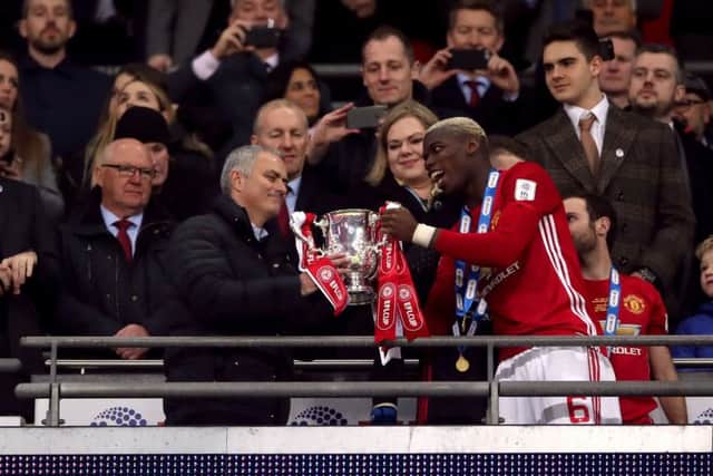 Midfielder Paul Pogba and manager Jose Mourinho - in his first season at Manchester United - hold the League Cup after victory over Southampton at Wembley in 2017 (Picture: Nick Potts/PA Wire).