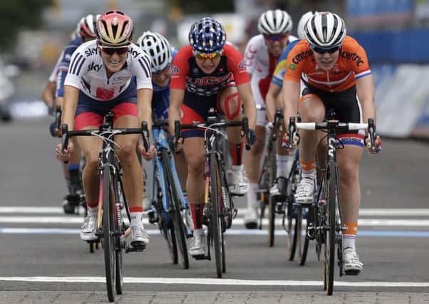 Elizabeth Armitstead, left, of Great Britain, passes Anna Van Der Breggen, right, of the Netherlands and Megan Guarnier, center, of the United States to the line to win the Women's Elite road circuit cycling race at the UCI Road World Championships in Richmond, Va., Saturday, Sept. 26, 2015. Van Der Breggen finished in second place and Guarnier was third. (AP Photo/Gerry Broome)