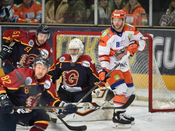 Rob Dowd tries to find a way past Chris Carrozzi in the Guildford goal on Wednesday night. Picture courtesy of John Uwins/EIHL.
