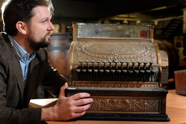 Auctioneer Steve Stockton with a late 18 century American National cash register from Helperby Manor