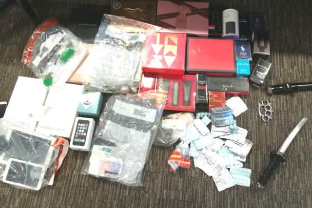 Cash, weapons and suspected stolen goods seized by police during a raid in Hull.