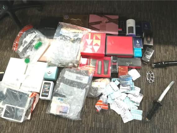 Cash, weapons and suspected stolen goods seized by police during a raid in Hull.