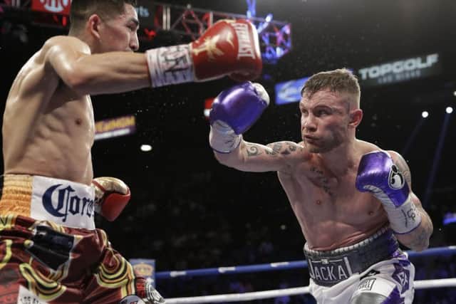 THREAT: Carl Frampton takes on Leo Santa Cruz during their featherweight title rematch in January last year in Las Vegas. Picture: AP/John Locher