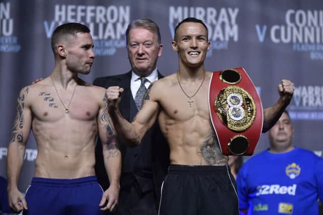 FIGHT GAME: Carl Frampton looks on at IBF featherweight champion Josh Warrington at Friday's weigh-in in Manchester. Picture: Steve Riding.