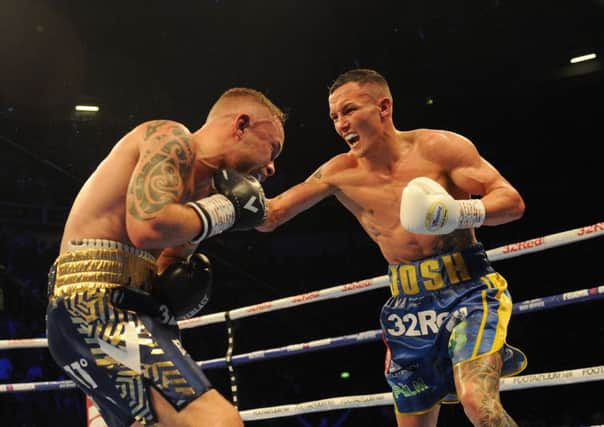 TAKE THAT: Josh Warrington on the attack as he retained his IBF world featherweight title against Carl Frampton in Manchester on Saturday nigvht. Picture: Steve Riding.