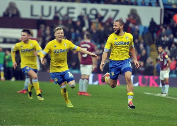 Team-mates find it difficult to keep up with Kemar Roofe after his dramatic stoppage-time winner for Leeds United who had trailed by two goals to Aston Villa at Villa Park (Picture: Tony Johnson).