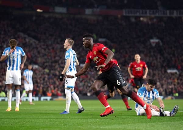 Manchester United's Paul Pogba celebrates scoring his side's second goal against Huddersfield Town. Picture: Martin Rickett/PA