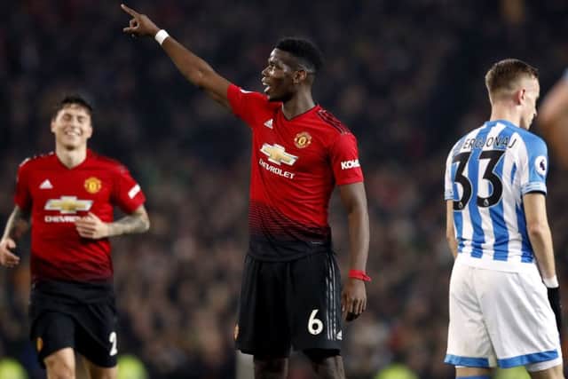 Manchester United's Paul Pogba celebrates scoring his side's third goal against Huddersfield Town Picture: Martin Rickett/PA