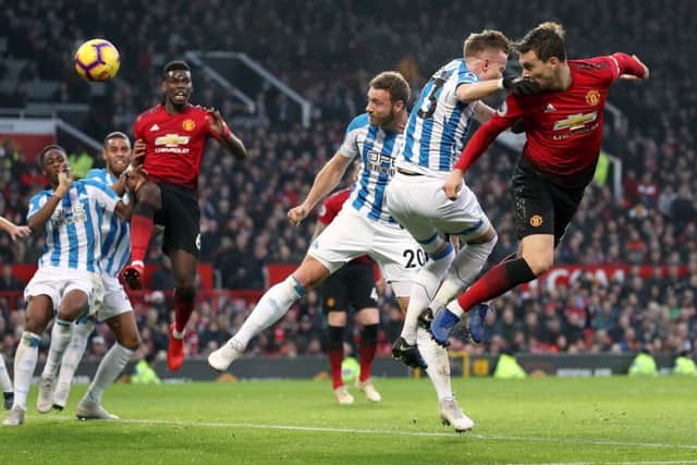 Manchester United's Victor Lindelof heads the ball towards the Huddersfield Town goal . Picture: Martin Rickett/PA