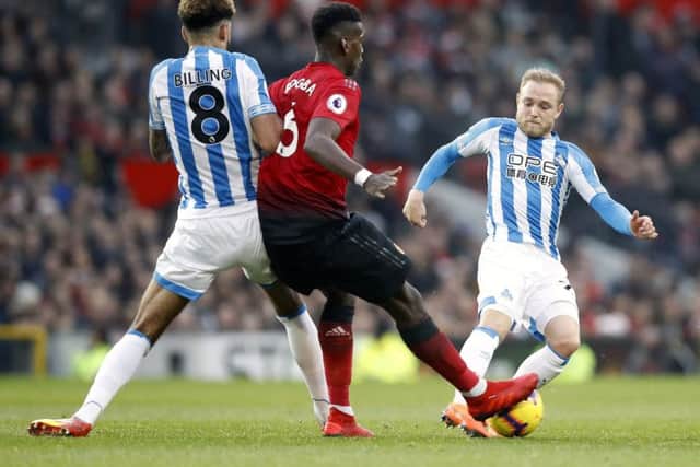Manchester United's Paul Pogba and Huddersfield Town's Alex Pritchard (right) battle for possession (Picture: PA)