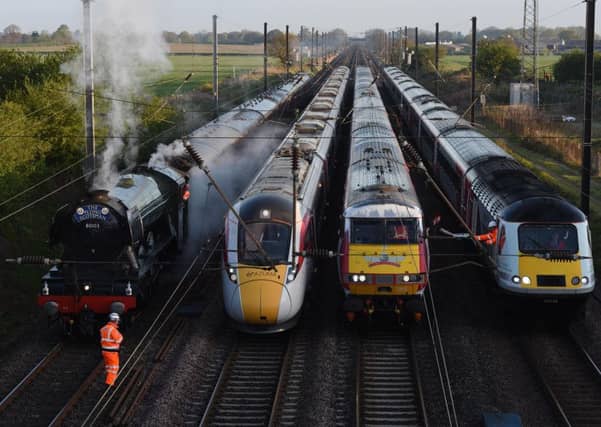 New trains planned for the East Coast mainline do not work properly with track-side equipment, it has emerged. The Azuma trains (pictured, second left) cause electromagnetic interference to older signals and points in the north of England. This means the electro-diesel trains can only run on diesel, travelling much more slowly than their promised speed. Network Rail said it was working with Japanese train manufacturer Hitachi to fix the problem but it was too early to identify a solution. FILE PICTURE - A Virgin Azuma Class 800 train (second left) side-by-side with The Flying Scotsman, an InterCity 225 Class 91 and a HST Class 43.