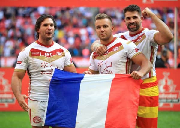 Josh Drinkwater, centre, with Catalan Dragons team-mates Julian Bousquet, left, and Mickael Simon at Wembley after their Challenge Cup final win (Picture: Adam Davy/PA Wire).