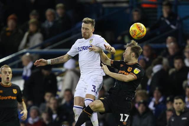 LOSING BATTLE: Leeds' Barry Douglas leaps with Hull's Todd Kane. Picture: Gareth Williams/AHPIX.com