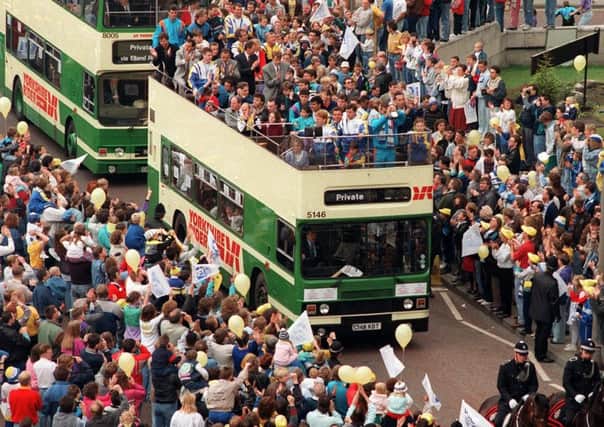 On parade: Leeds United players on their tour of the city after winning the Division Two Championship in 1990.
