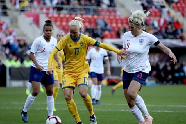 England's Millie Bright, right, battles with Sweden's Caroline Seger at the New York Stadium. Picture: Tim Goode/PA