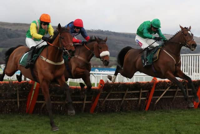 Eventual winner Midnight Shadow ridden by Danny Cook (left) jumps the last with Old Guard ridden by Harry Cobden (centre) and Wholestone ridden by Daryl Jacob (right) in the Dornan Engineering Relkeel Hurdle at Cheltneham.