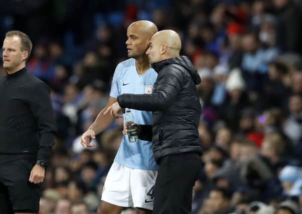 IN IT TO WIN IT: Manchester City manager Pep Guardiola (right) and Vincent Kompany. Picture: Martin Rickett/PA