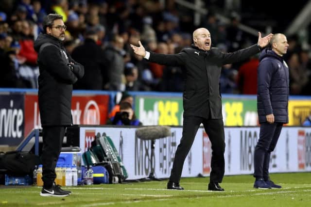 HIGHS AND LOWS: Huddersfield Town head coach, David Wagner, left, and Burnley manager Sean Dyche, on the touchline at the John Smith's Stadium tonight. Picture: Martin Rickett/PA