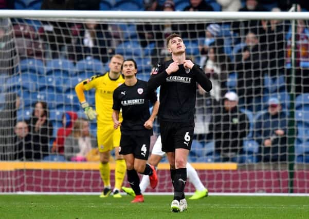 Barnsley's Liam Lindsay appears dejected after Burnley's Chris Wood scores.