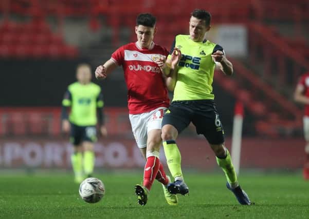 Huddersfield's Jonathan Hogg and Bristol City's Callum O'Dowda during the Emirates FA Cup, third round match.