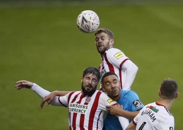 Sheffield United's Martin Cranie and Kieron Freeman attempt to win an aerial duel against Barnet (Picture: Simon Bellis/Sportimage).