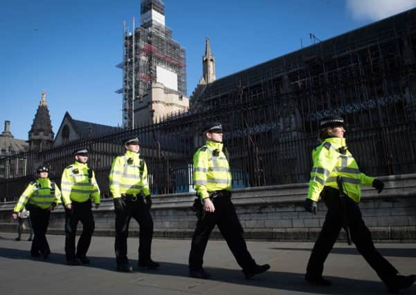 Metropolitan Police officers stand outside the  Houses of Parliament in London as police near Parliament have been "briefed to intervene appropriately" if the law is broken after Tory MP Anna Soubry accused them of ignoring abuse hurled at politicians and journalists.