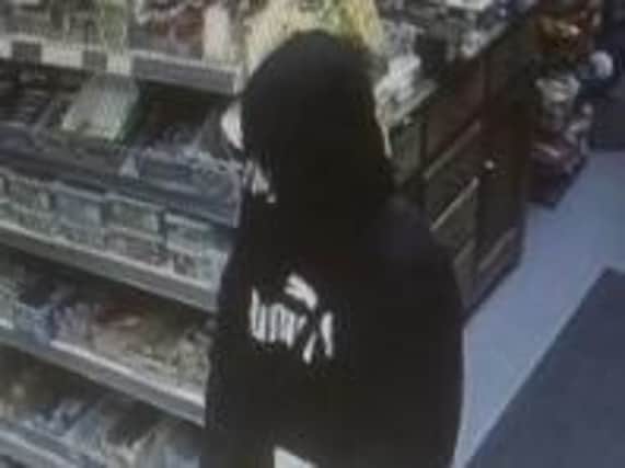 Police investigating a knifepoint robbery at a newsagents in Mirfield have released this CCTV image.