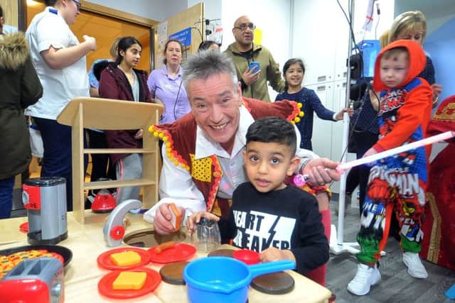Panto king Billy Pearce with Raheem Mehmood, 3, on the childrens ward at  the Bradford Royal Infirmary. The cast of Aladdin at the Alhambra took a break from their performances to visit the Children and Young Persons Unit at the BRI. Picture Tony Johnson.