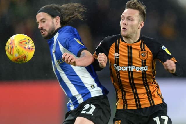 Wednesday's George Boyd holds off Hull City's Todd Kane (Picture: Steve Ellis)