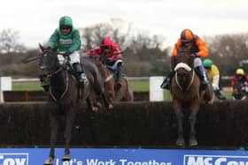 Sam Waley-Cohen and Impulsive Star, right, trail Callet Mad, ridden by James Bowen, over the last fence before going on to win at Warwick on Saturday (Picture: Julian Herbert/PA Wire).