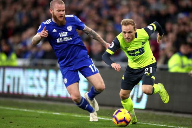 Cardiff City's Aron Gunnarsson (left) and Huddersfield Town's Alex Pritchard (right) battle for the ball (Pictures: PA)