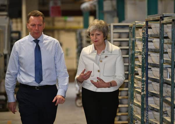 Prime Minister Theresa May with production manager Rob Findler during a visit to the Portmeirion factory in Stoke-on-Trent. as she tried to win 11th hour support for her Brexit deal.