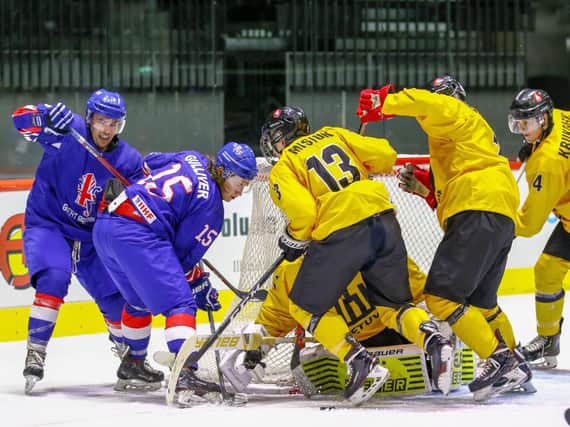 Harry Gulliver battles to get the puck through on the Lithuanian goal. Picture courtesy of Hendrik Soots.