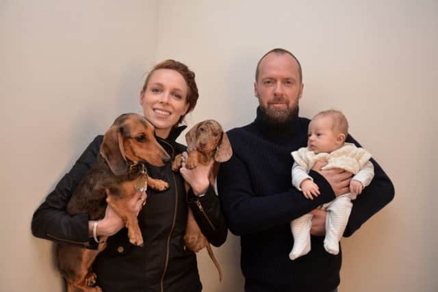 Tessa Weale holds her dogs Hector and Horace, while Julian Turner holds Tessa's baby, Errol.